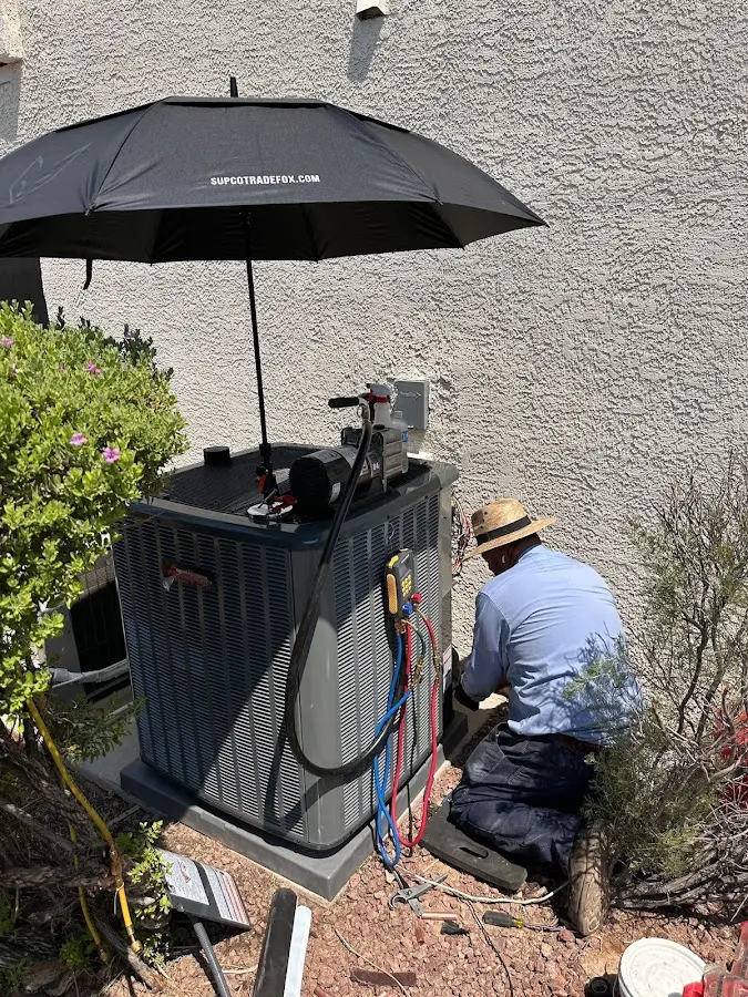 HVAC technician performing outdoor AC maintenance in Yarmouth